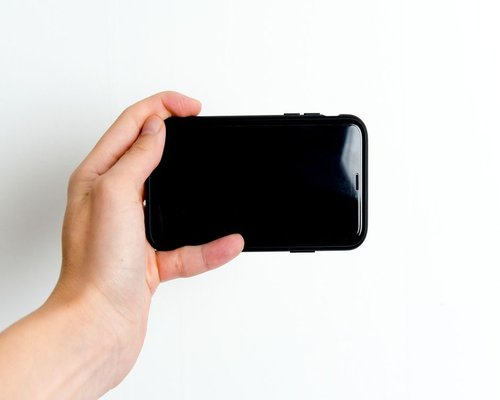 Person holding smartphone with relaxed grip